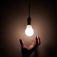 person holding white light bulb