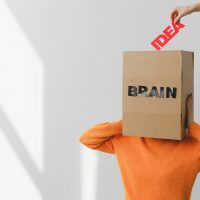 box with brain inscription on head of anonymous woman