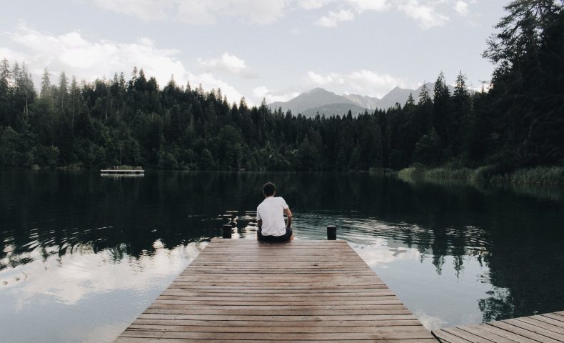 man sitting on dock
