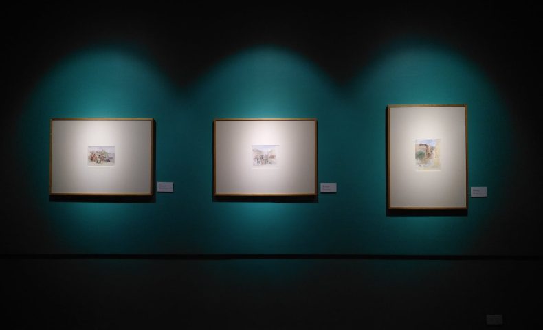 three paintings hanging in gallery