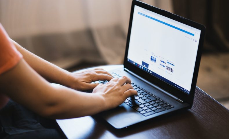 person typing on laptop