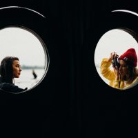 two women near windowpane