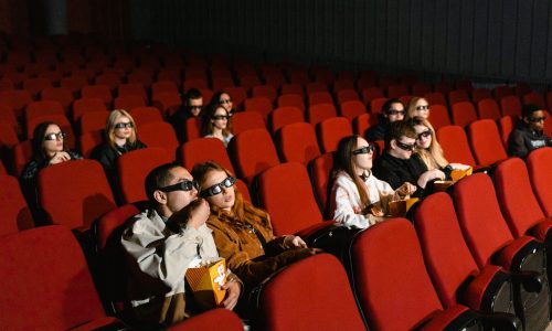 people sitting on red chairs