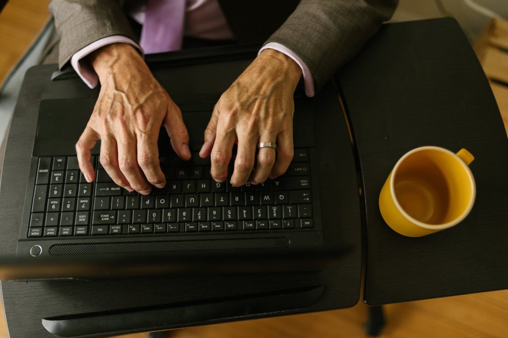 person typing on black laptop computer