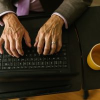 person typing on black laptop computer