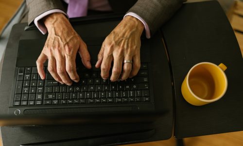 person typing on black laptop computer