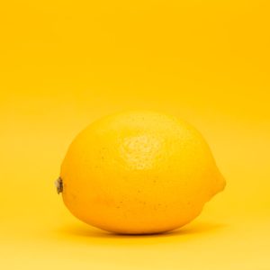 yellow lemon fruit on white surface