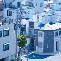 utility poles beside the concrete houses
