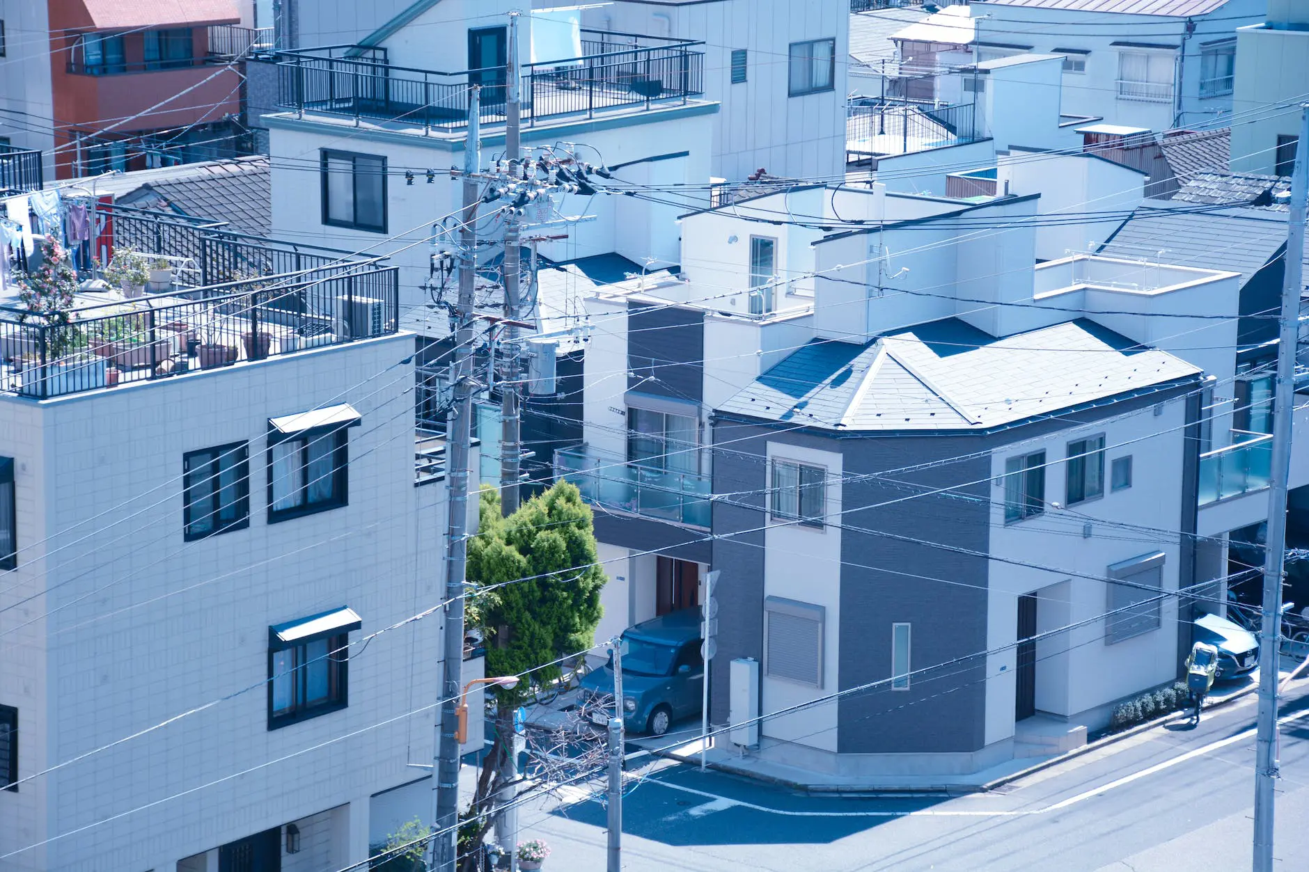 utility poles beside the concrete houses