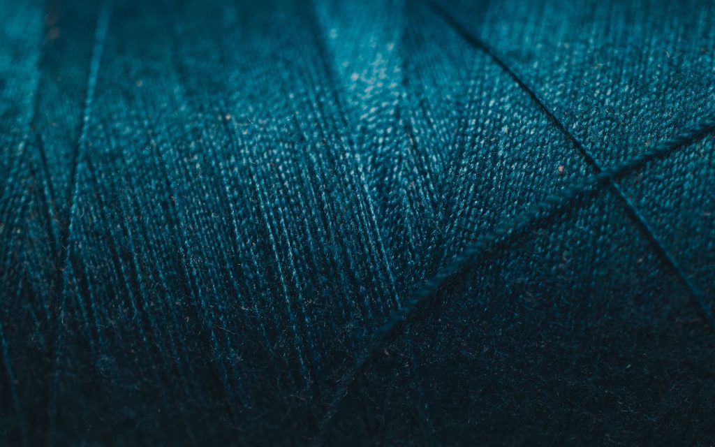 close up photo of blue thread